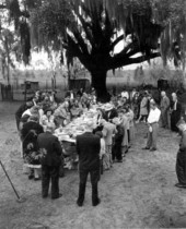 People at the Cracker Feast praying around a picnic table - Gilchrist County, Florida
