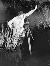 Herman Terrill standing in water surveys untouched township - Copeland, Florida