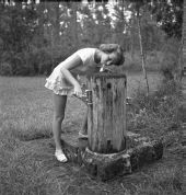 Martha Green drinks from a water fountain - Sebring, Florida .