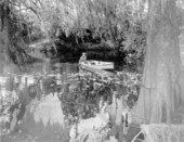 Howe Sadler paddles a boat on the river - Thonotosassa, Florida