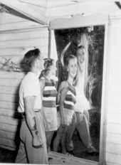 Bernard Buck and Phyllis Trask stand before a funny mirror