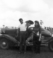 Man displaying his turkey prize at Naples' Swamp Buggy Day.