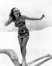 Ann Williamson of Winter Haven, Florida, posing with driftwood on the beach.
