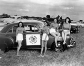 Young ladies pose with a car during an orange picking contest - Orlando, Florida.