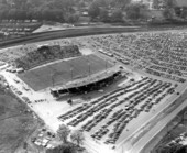 Aerial view of Doak Campbell Stadium with surrounding parking lot during dedication football game - Tallahassee, Florida.