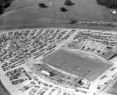 Aerial view of Doak Campbell Stadium with parking lots during dedication football game - Tallahassee, Florida.