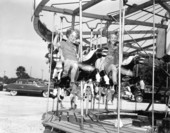 Children enjoying the merry-go-round at the watermelon festival carnival - Leesburg, Florida