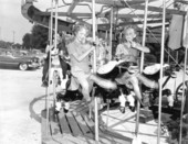 Children enjoying the merry-go-round at the watermelon festival carnival - Leesburg, Florida