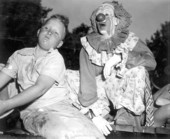 Young boy and clown at the watermelon eating contest in the watermelon festival - Leesburg, Florida