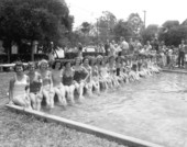 Beauty contestants seated at the edge of a pool in the watermelon festival - Leesburg, Florida