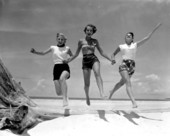 Three young women frolic along the beach - St. George Island, Florida