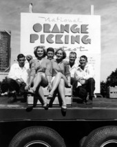 Young ladies and men pose on a truck at contest - Orlando, Florida.