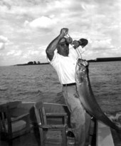 Fisherman Beverly Grizzard showing his 80 pound tarpon catch - Boca Grande, Florida