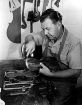 Violin maker Dudley Reed restoring a violin.