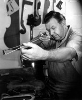 Violin maker Dudley Reed checking a violin bow.