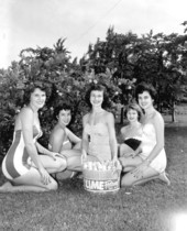 Young women pose for photographs during the Key Lime Festival - Key Largo, Florida
