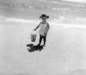 Two year old Karen Moore on the beach with her pail and shovel - Panama City, Florida.
