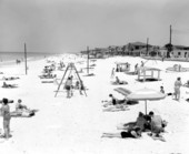 People enjoying the sun at the beach - Panama City Beach, Florida.