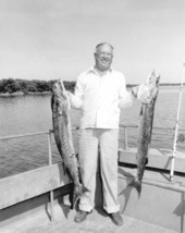 Fisherman proudly displaying two large barracudas - Florida Keys, Florida