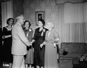 Hostesses greeting a guest at Governor Collins' inaugural reception at the Mansion - Tallahassee, Florida.