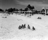 Kids play in the sand on the beach.