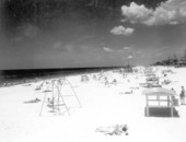 Swings and cabañas provide recreation and comfort at the beach.