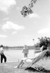 Mamie Johnson and two young children relax beside the river, at Port Paradise Hotel - Crystal River, Florida