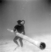Divers holds on to pipe at Capitana wreck site - Plantation Key, Florida .