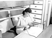 Woman ironing aboard a houseboat in Fort Lauderdale