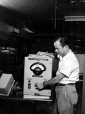Engineer J. L. Moody adjusting controls on company-invented Indexometer in Umatilla, Florida.