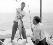A man holding a king mackerel caught by a fisherman - Destin, Florida.