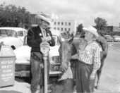 Senator Newman Brackin playfully accepts a parking ticket for overtime on his horse - Crestview, Florida