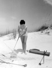 Marie Fajardo playing golf on the Daytona Beach sand