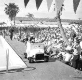 Clown performing for audience at a swimming pool for the Tri-city suncoast festival - Redington Beach, Florida.
