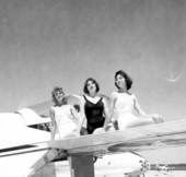 Young women pose on a Blue Angels airplane during the anniversary of a Naval air station - Pensacola, Florida.