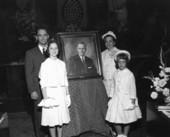 House Speaker William V. Chappell standing with his family by his portrait on opening day of the Florida Legislature.