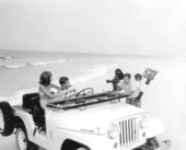 Motion picture filming on a beach.