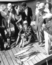 Onlookers stare at several freshly caught kingfish - Riviera Beach, Florida.