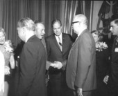 Walt Disney shaking hands with man during press conference - Orlando, Florida.
