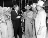 Wendell Jarrard talking with people dressed up as farm folk.