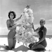 Young women posing with Christmas tree on the beach - Pensacola, Florida.