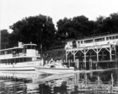 View of boat passing in front of Noah's Ark by the Sportsman's Lodge.