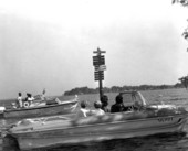 Boaters on Oklawaha River cruise at sign - Lake Eustis, Florida