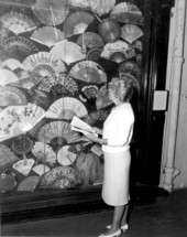 A staff member looking at the fan collection at the Lightner Museum - Saint Augustine, Florida