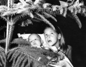 Adriana Dolabella and younger sister Claudia Kirk looking at christmas tree.