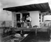Two men grilling at a fishing shack sitting on tidal flats - Marquesas Keys, Florida