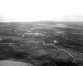 Aerial view of an industrial site, with municipal airport in the background - Apalachicola, Florida.