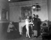 A young woman stands between two figures displayed at Potter's Wax Museum - Saint Augustine, Florida