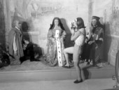 A young woman taking a picture for three figures displayed at Potter's Wax Museum - Saint Augustine, Florida