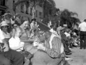 Costumed pirate entertains children during the Gasparilla parade - Tampa, Florida.